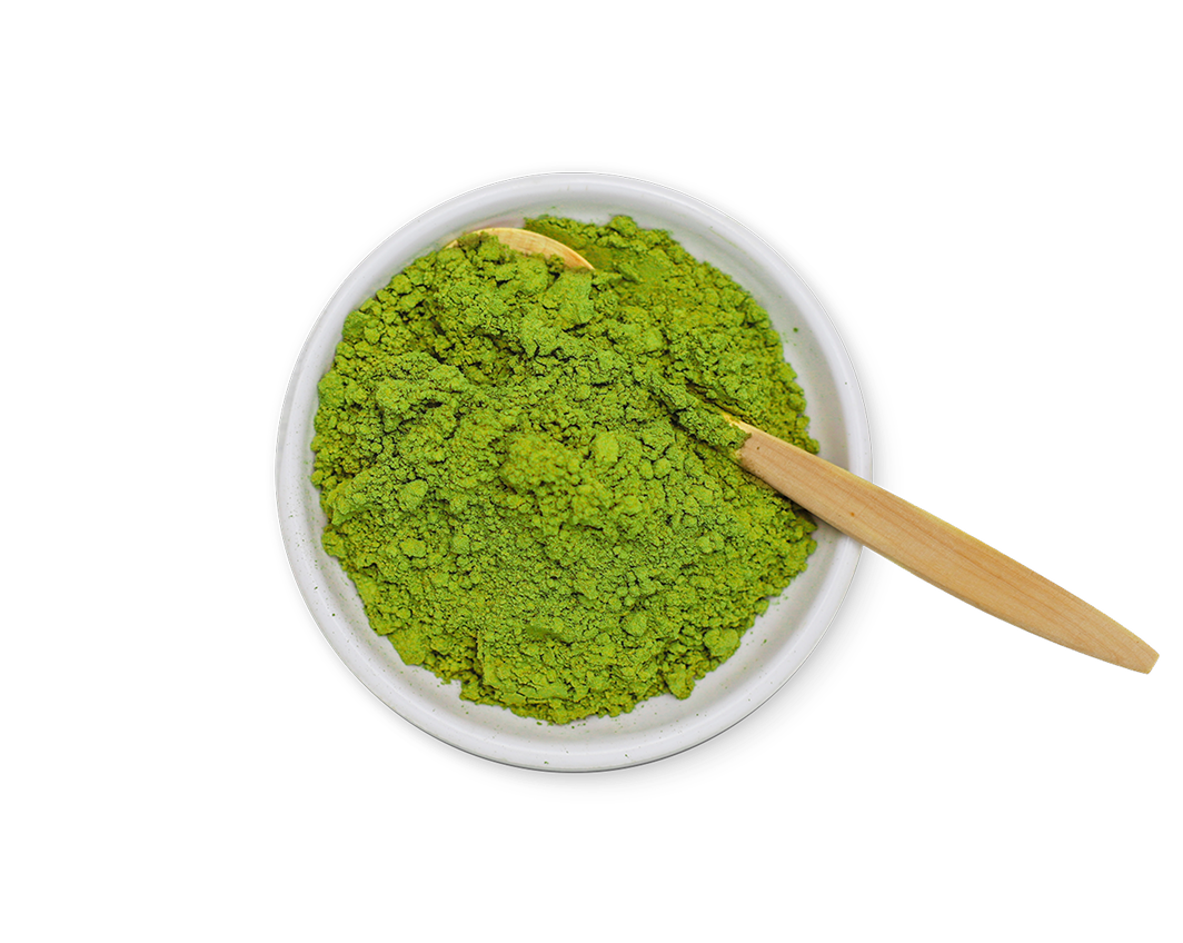 Green l-theanine powder in a white bowl with a wooden spoon on a white background