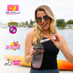 Woman holding a water bottle and a Vibras supplement stick with product call outs on a lake background